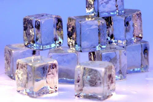 Ice cubes arranged on a reflective surface