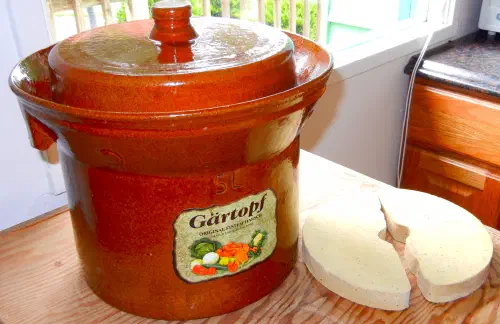Traditional ceramic fermentation weights in a Harsch crock