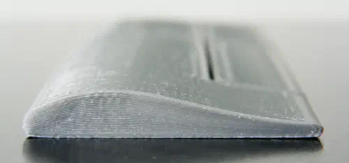 3D printer depositing curved non-planar layers on an airplane wing print