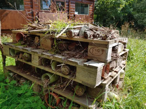 Bug hotel made of recycled pallets and bricks