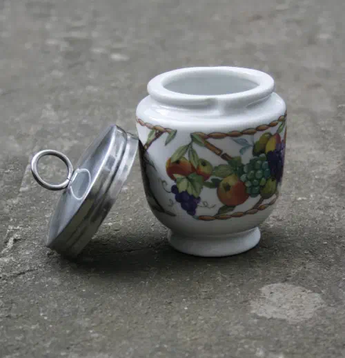 Traditional porcelain egg coddler with floral design and metal lid